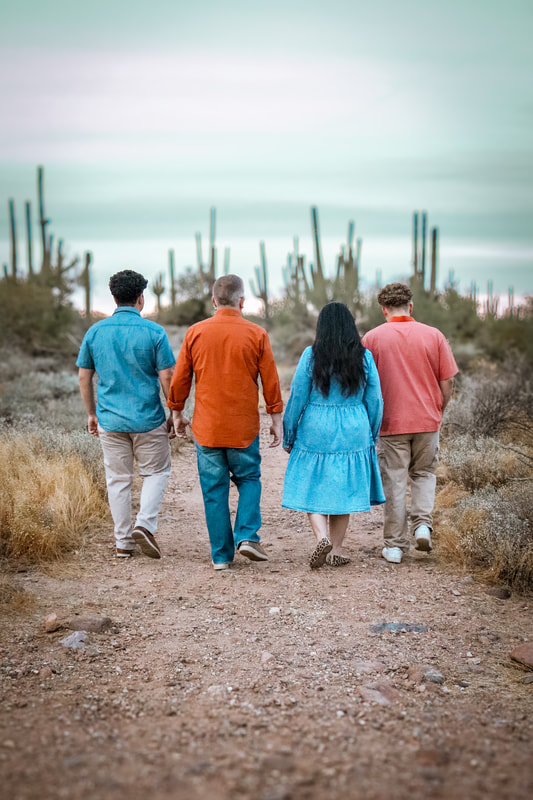 Family walking through the desert at golden hour